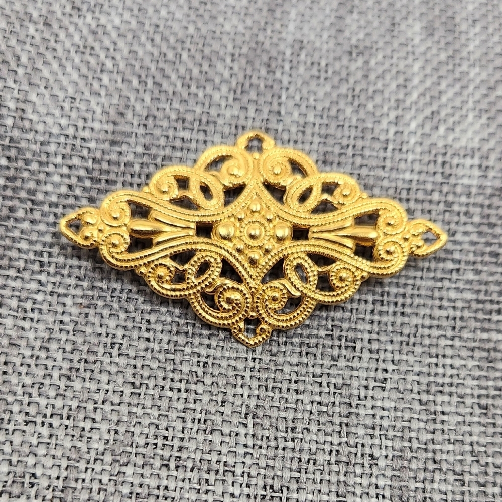 Monet Goldtone Openwork Diamond Shaped Brooch. 